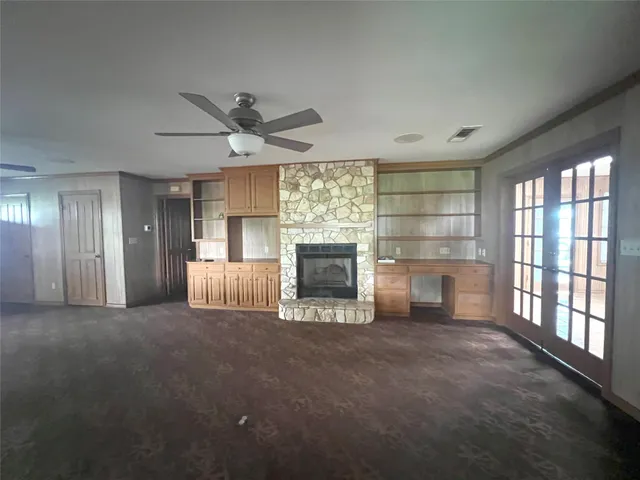 a view of a livingroom with a fireplace and window