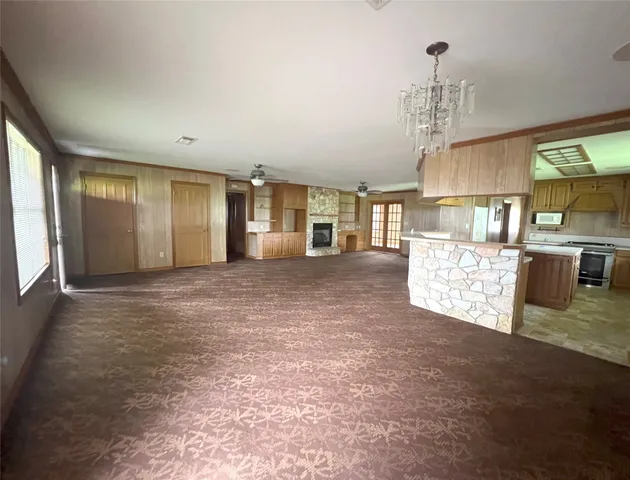 a view of a kitchen with kitchen island and stainless steel appliances