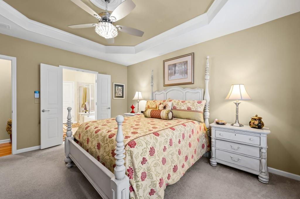 1081 Spring Station Road Greensboro, GA 30642 - Photo 19 of 35 a bedroom with a bed and a chandelier