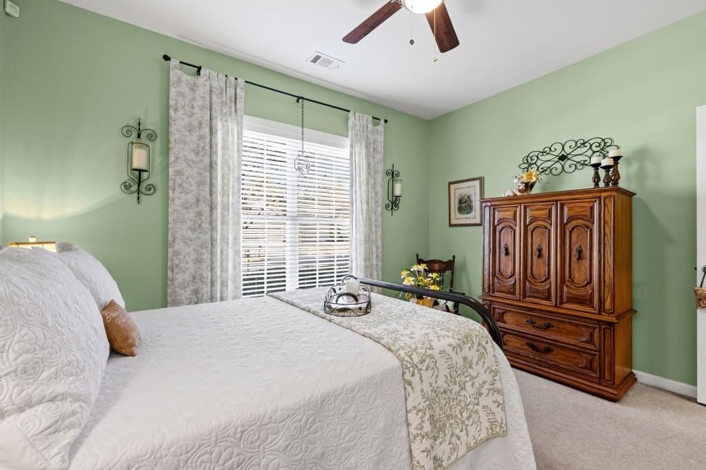 1081 Spring Station Road Greensboro, GA 30642 - Photo 26 of 35 a bedroom with a bed and wooden floor