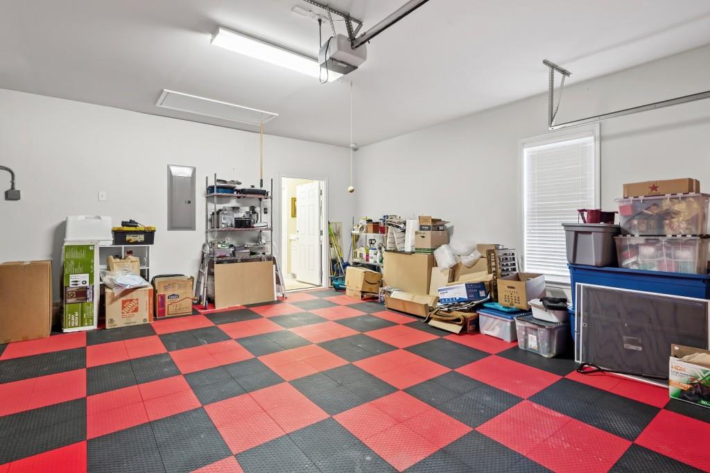 1081 Spring Station Road Greensboro, GA 30642 - Photo 30 of 35 a living room with a black white checkered floor kitchen view and a dining table