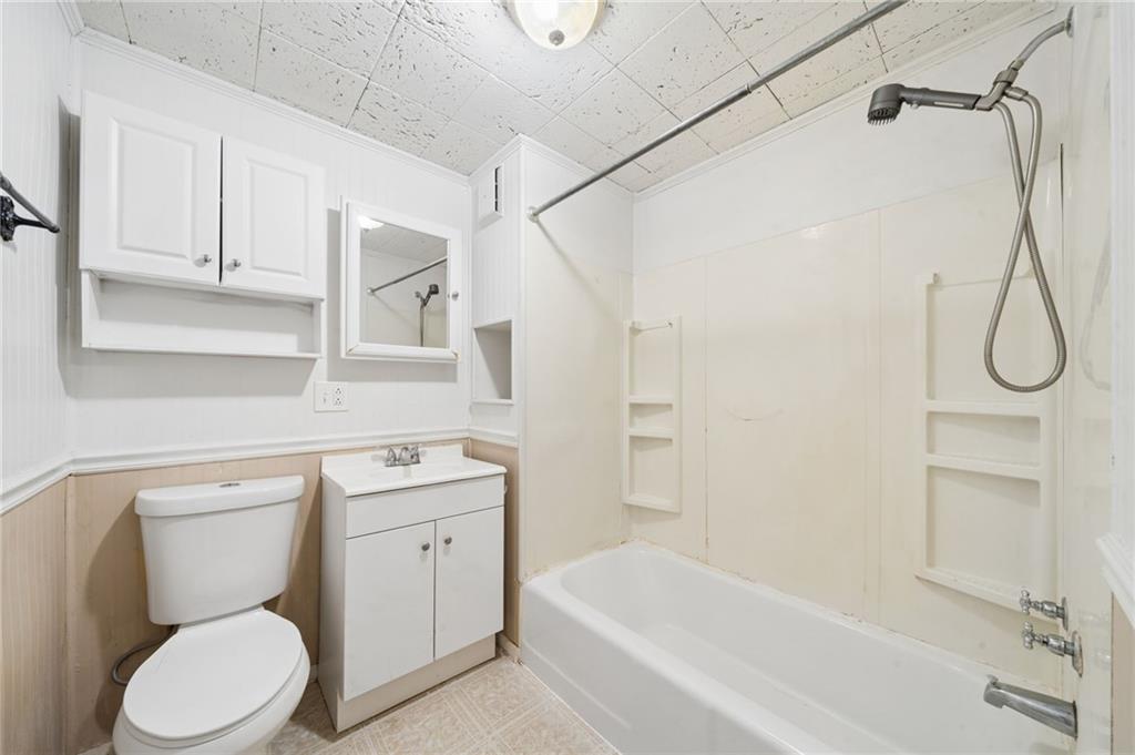 680 Main Street Irwin, PA 15642 - Photo 5 of 41 a bathroom with a toilet sink and shower