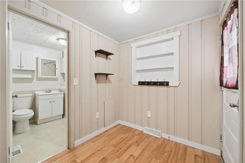 680 Main Street Irwin, PA 15642 - Photo 6 of 41 a bathroom with a toilet sink and a mirror