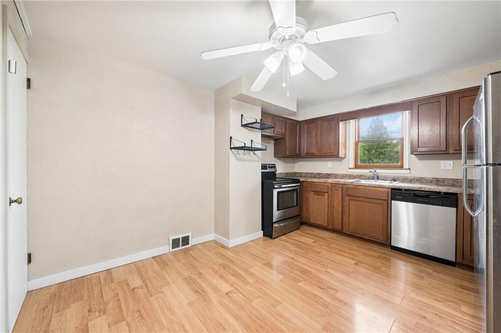 680 Main Street Irwin, PA 15642 - Photo 7 of 41 a kitchen with granite countertop stainless steel appliances a sink cabinets and a window