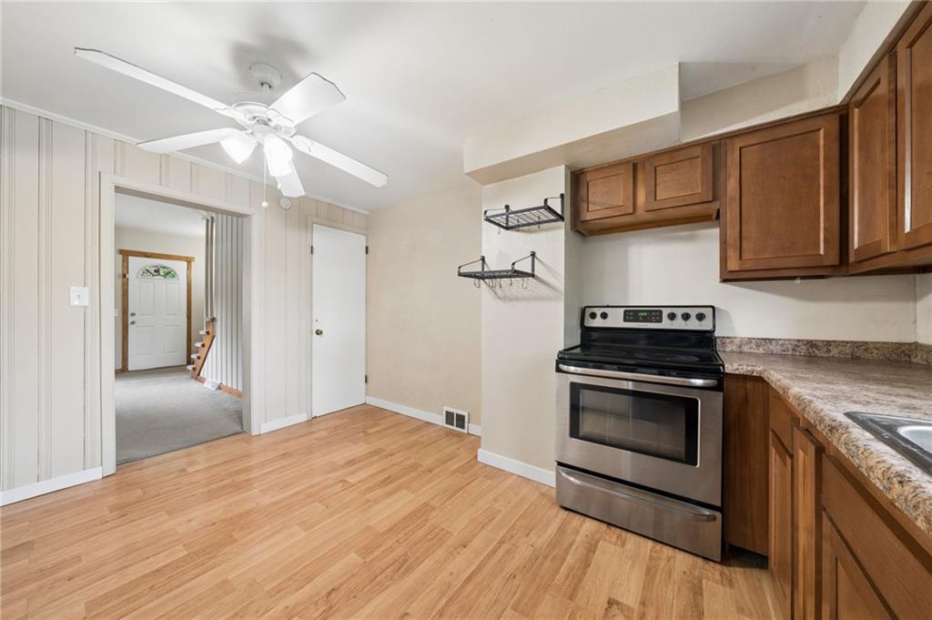 680 Main Street Irwin, PA 15642 - Photo 8 of 41 a kitchen with stainless steel appliances granite countertop a stove and a refrigerator