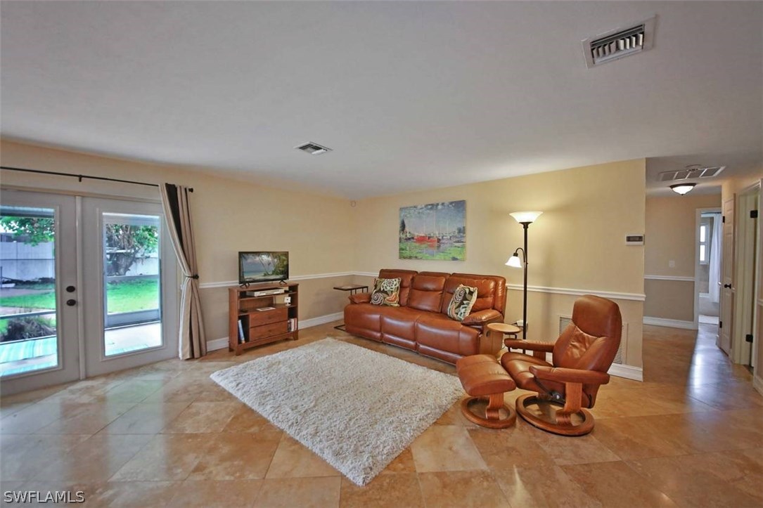 1650 North Mayfair Road Fort Myers, FL 33919 - Photo 3 of 24 a living room with furniture and a wooden floor