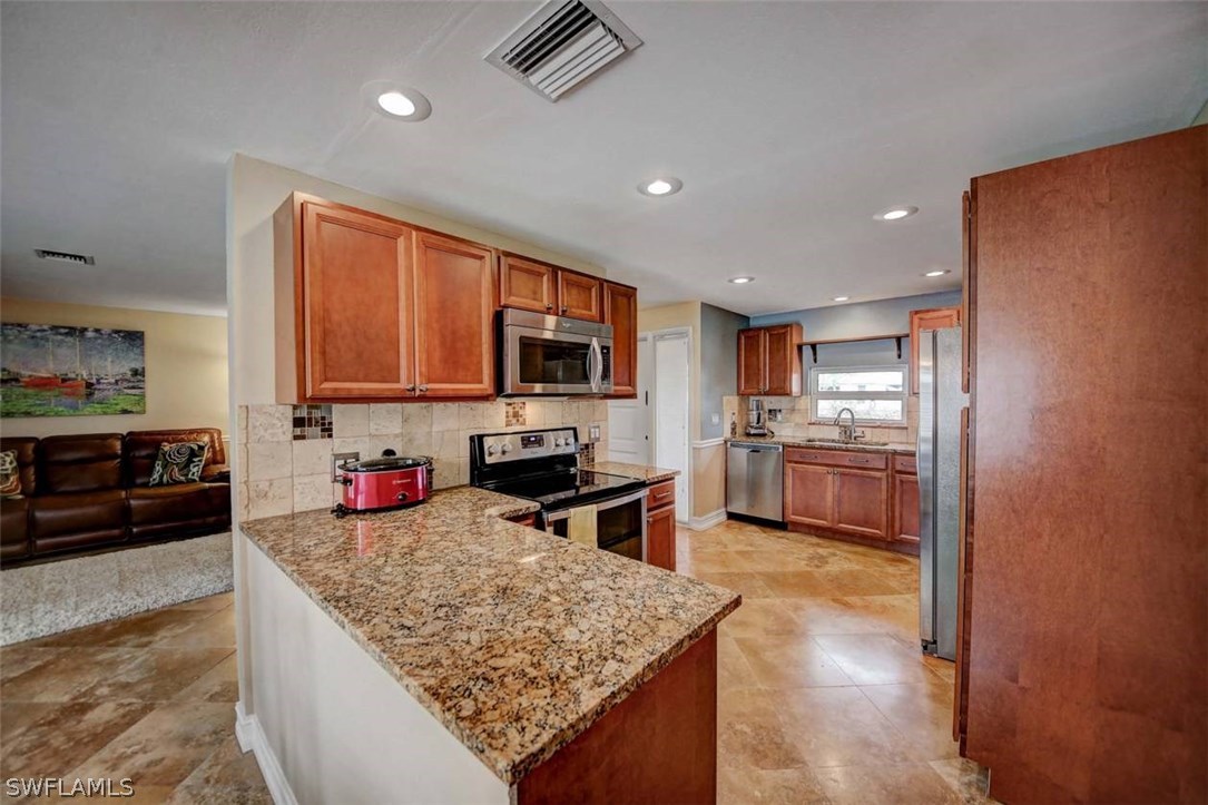 1650 North Mayfair Road Fort Myers, FL 33919 - Photo 7 of 24 a kitchen with a sink stove and refrigerator