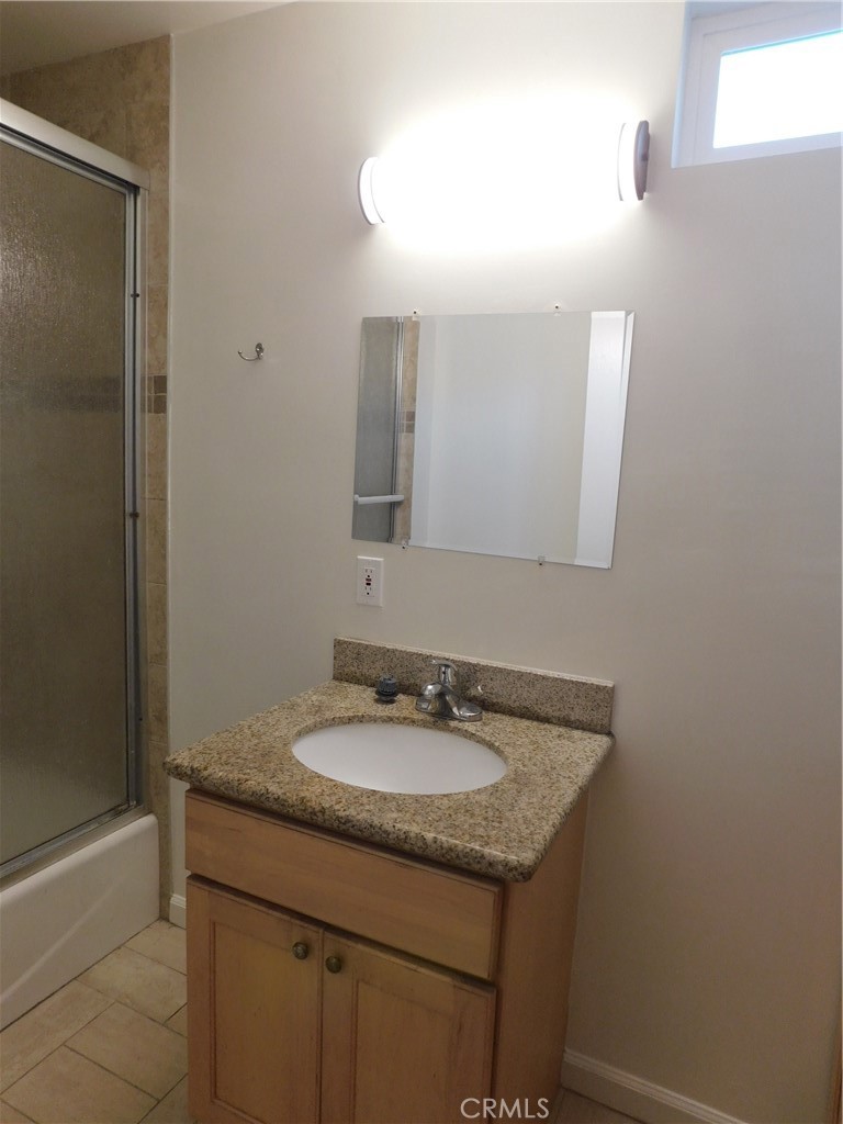 755 Valley View Avenue, Unit B Monrovia, CA 91016 - Photo 15 of 25 a bathroom with a granite countertop sink and a mirror