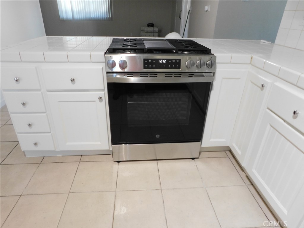 755 Valley View Avenue, Unit B Monrovia, CA 91016 - Photo 4 of 25 a stove top oven sitting inside of a kitchen