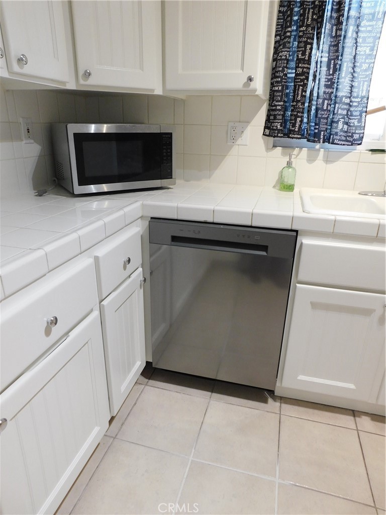 755 Valley View Avenue, Unit B Monrovia, CA 91016 - Photo 5 of 25 a kitchen with white cabinets and appliances