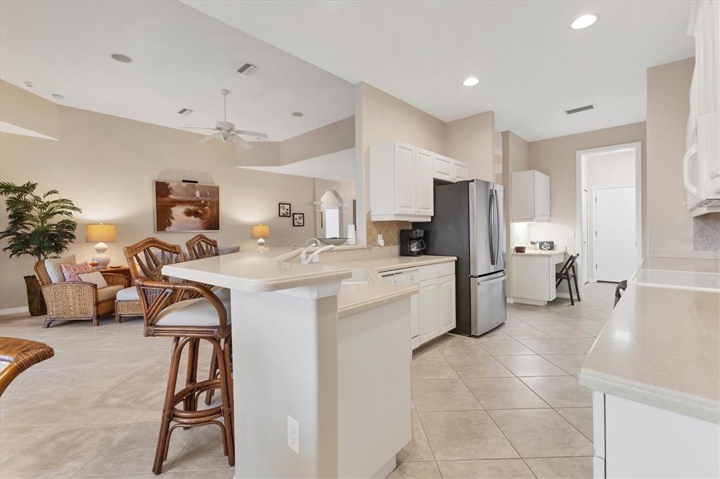 7 Windward Road Placida, FL 33946 - Photo 13 of 34 a kitchen that has a lot of white cabinets a sink and a refrigerator