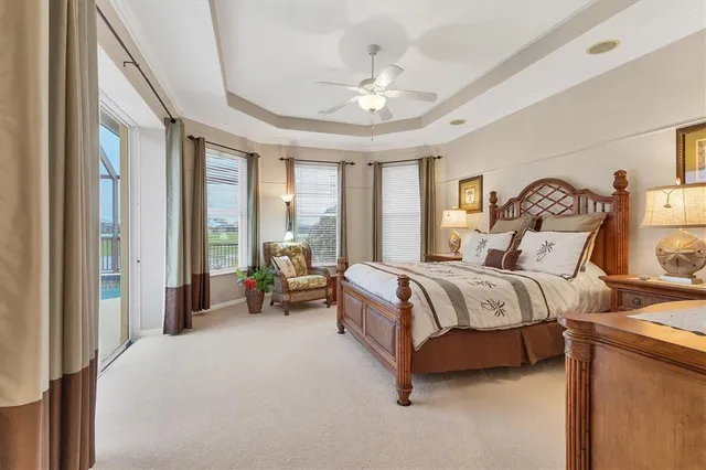 a spacious bedroom with a bed and a chandelier