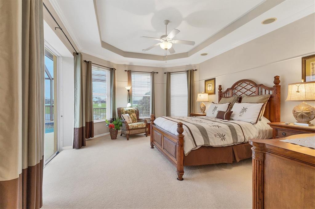 7 Windward Road Placida, FL 33946 - Photo 18 of 34 a spacious bedroom with a bed and a chandelier