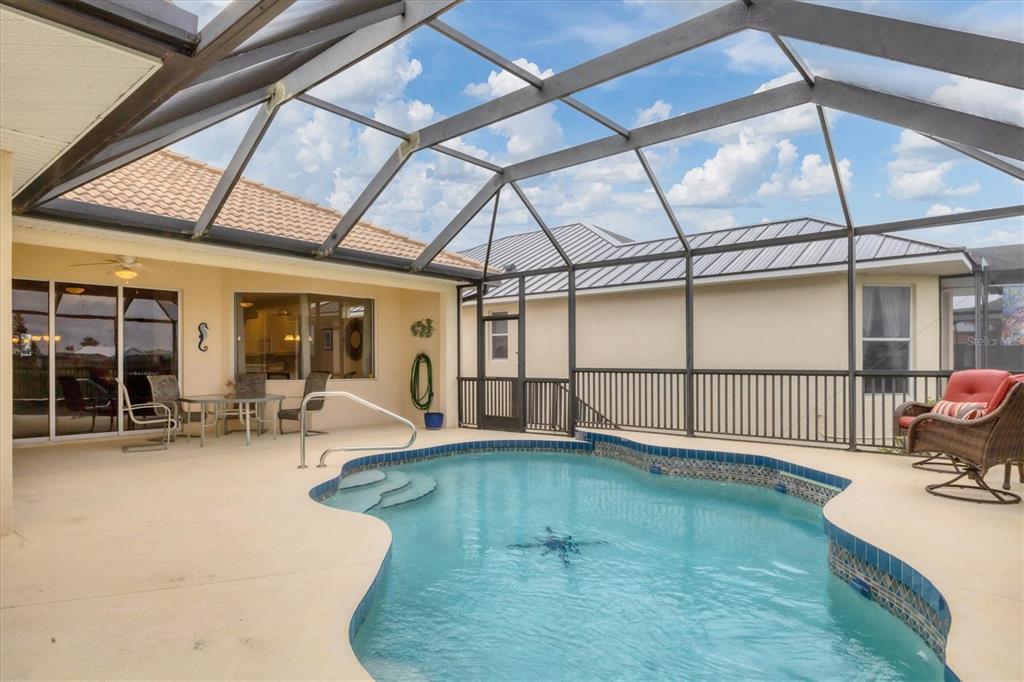 7 Windward Road Placida, FL 33946 - Photo 29 of 34 a swimming pool with outdoor seating and yard