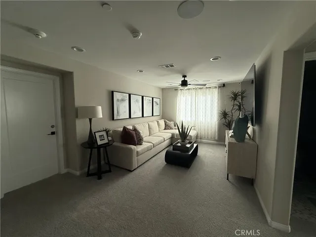 a living room with furniture and a chandelier