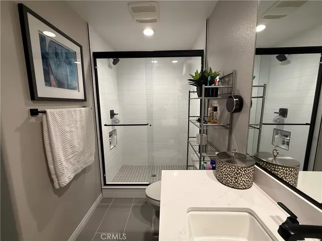 a bathroom with a shower and a sink