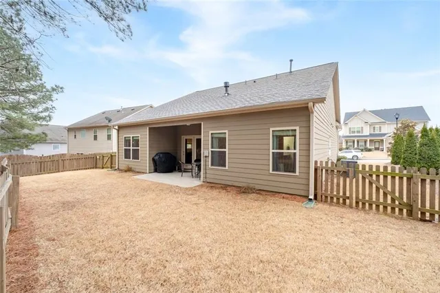 a view of a house with wooden fence