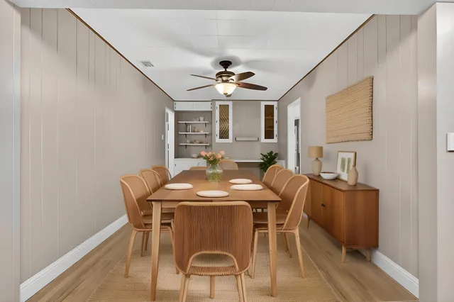 a view of a dining room with furniture and a chandelier