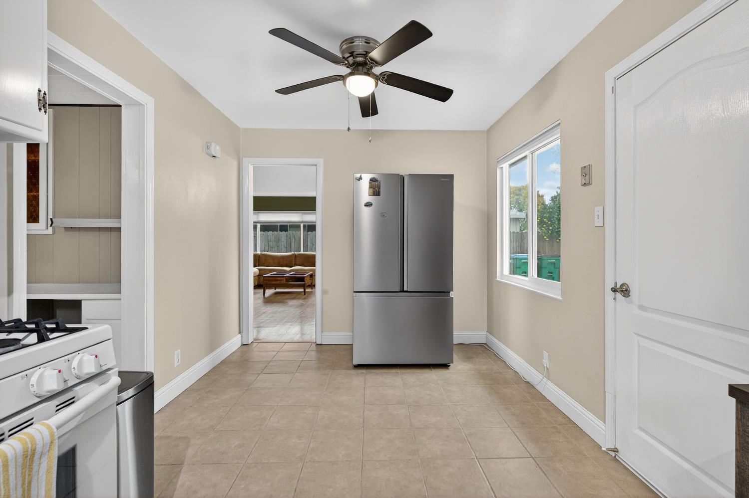 1507 West Locust Street Lodi, CA 95242 - Photo 11 of 28 a kitchen with stainless steel appliances granite countertop a refrigerator a stove a sink and a window