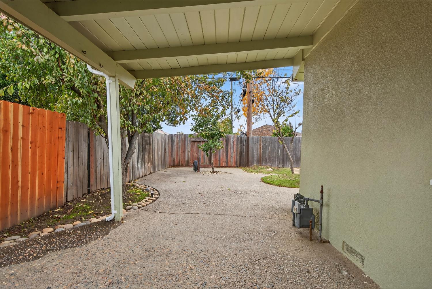 1507 West Locust Street Lodi, CA 95242 - Photo 24 of 28 a view of a backyard with a small cabin and wooden fence