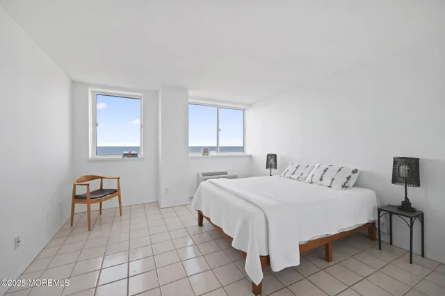 a bedroom with a bed and a lamp with dresser