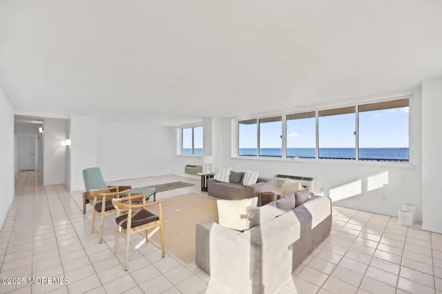 a living room with furniture a dining table and a large window