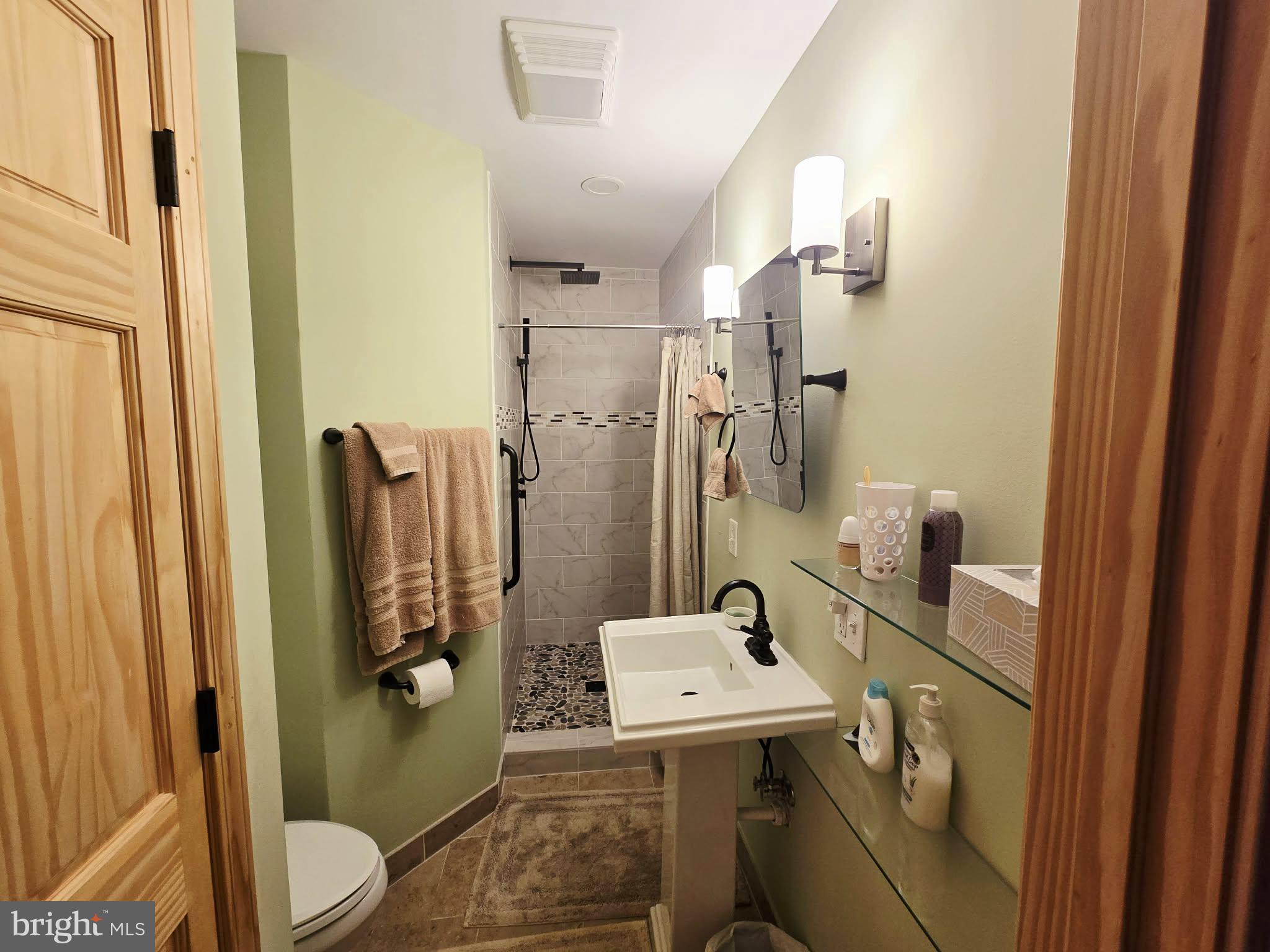 1120 Sandy Ridge Road Sugar Grove, WV 26815 - Photo 14 of 53 a bathroom with a sink toilet and shower