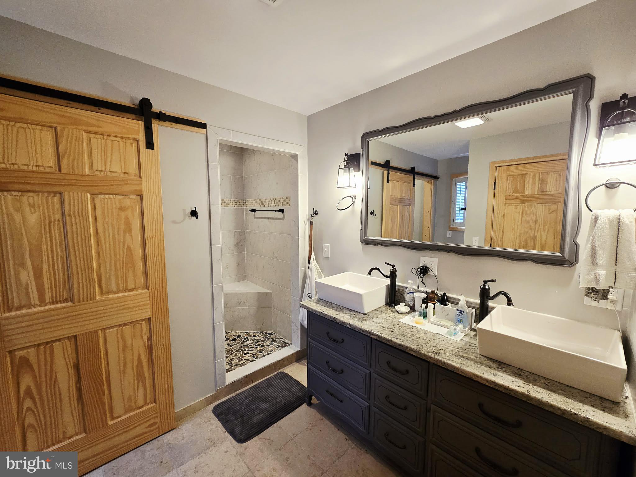 1120 Sandy Ridge Road Sugar Grove, WV 26815 - Photo 20 of 53 a bathroom with a double vanity sink and a mirror