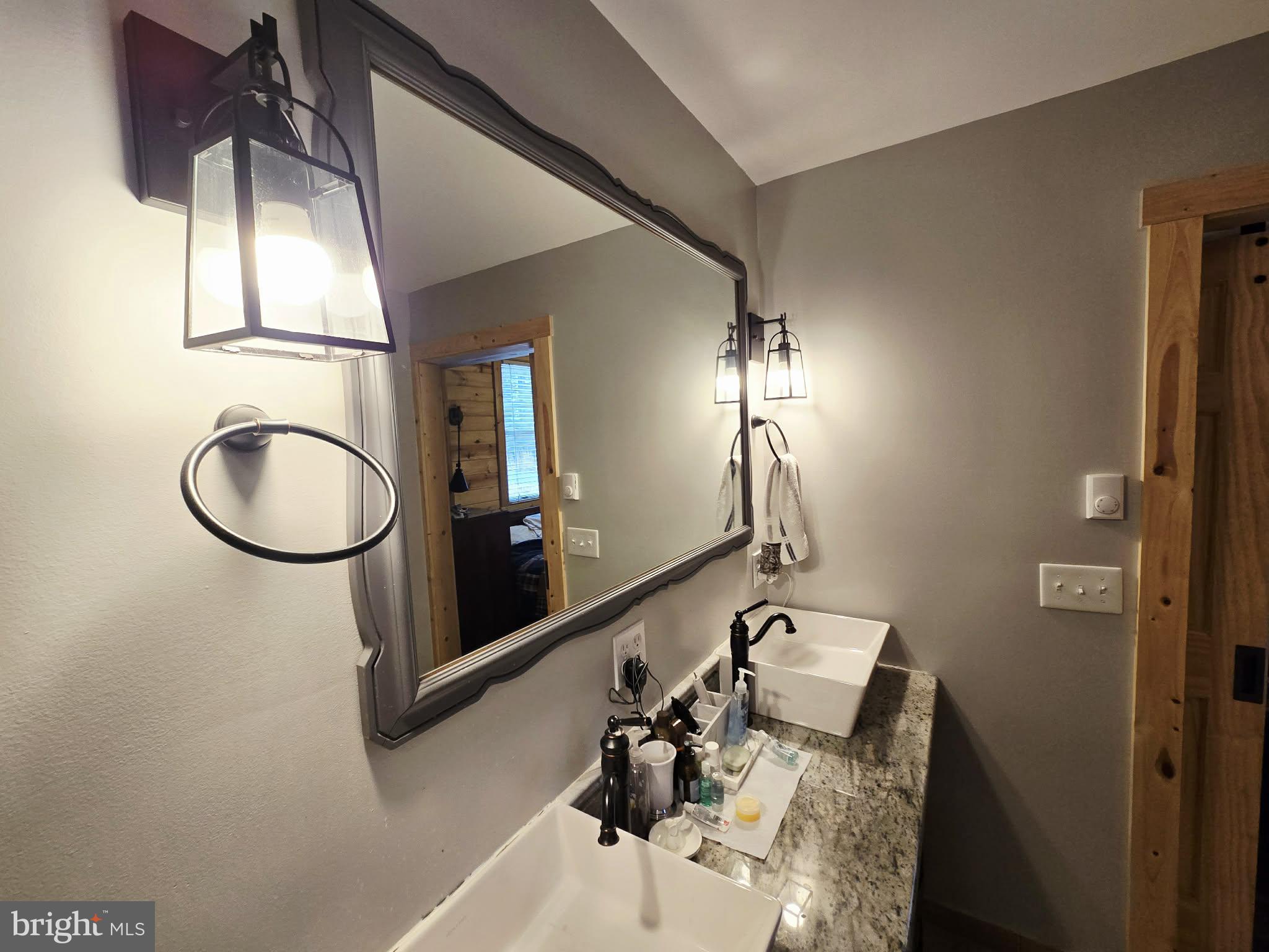 1120 Sandy Ridge Road Sugar Grove, WV 26815 - Photo 26 of 53 a bathroom with a sink and a mirror