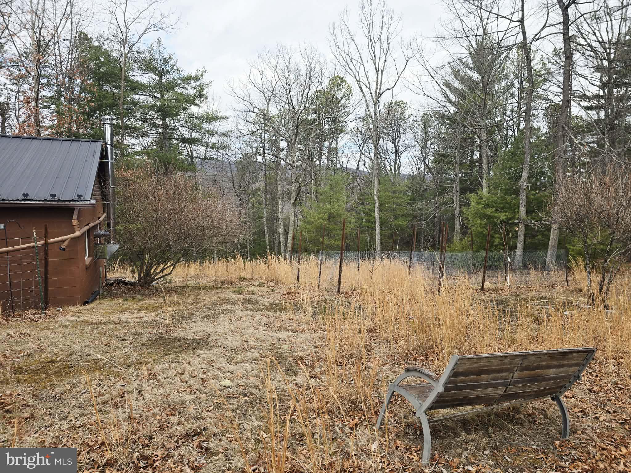 1120 Sandy Ridge Road Sugar Grove, WV 26815 - Photo 36 of 53 a backyard of a house with lots of green space and outdoor seating