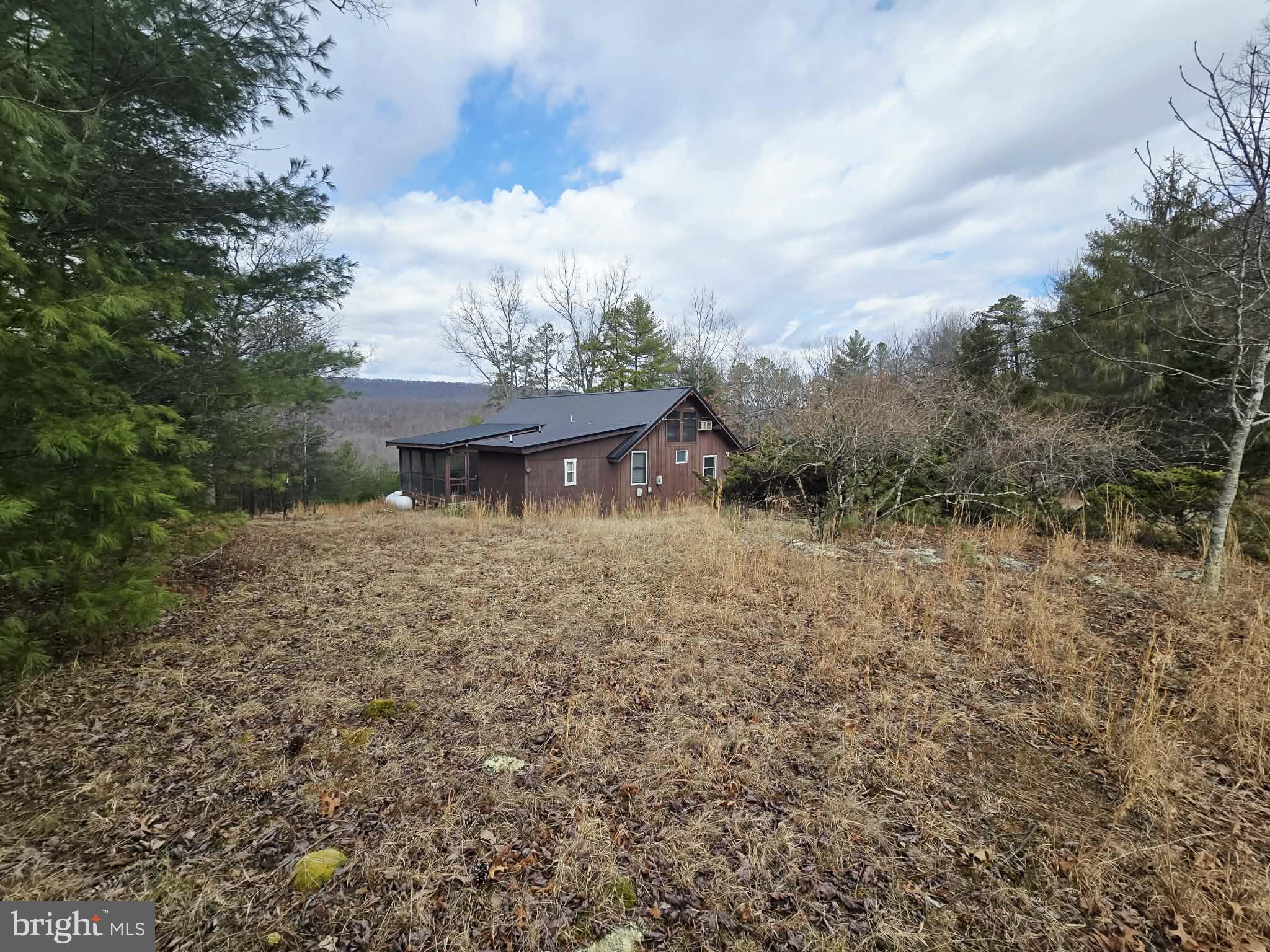 1120 Sandy Ridge Road Sugar Grove, WV 26815 - Photo 37 of 53 a view of a house with a yard and sitting area