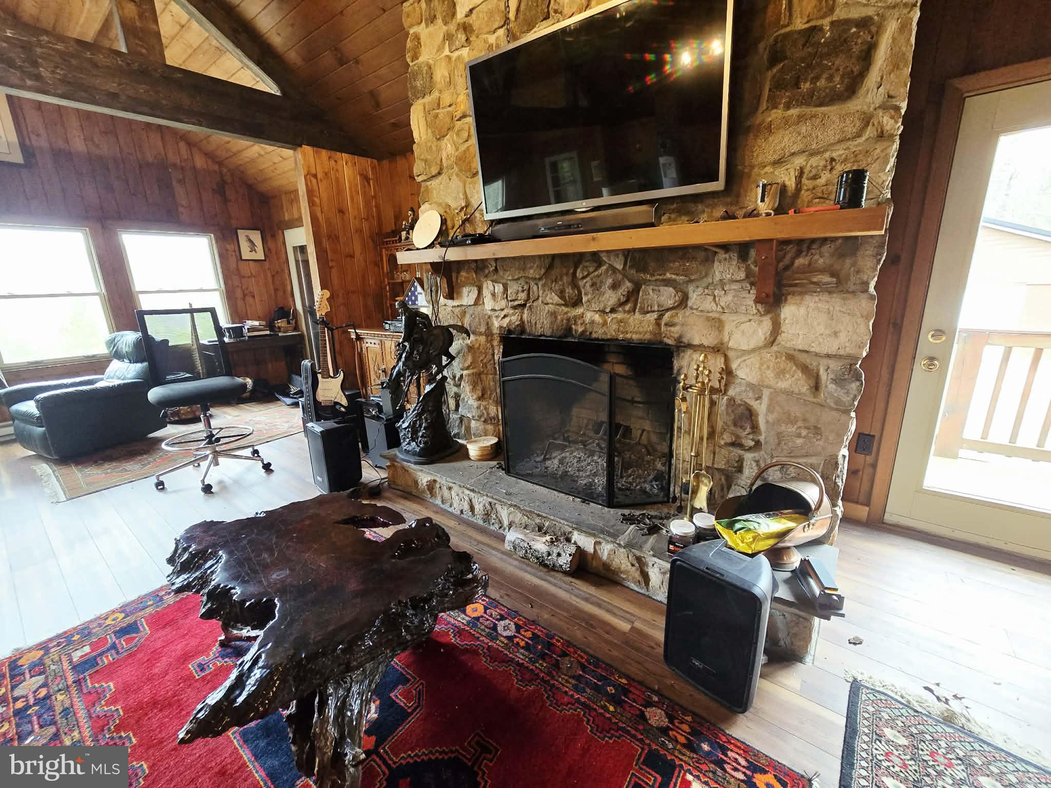 1120 Sandy Ridge Road Sugar Grove, WV 26815 - Photo 4 of 53 a living room with furniture a flat screen tv and a fireplace