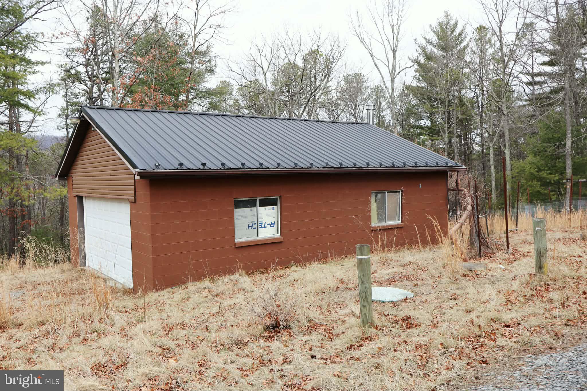 1120 Sandy Ridge Road Sugar Grove, WV 26815 - Photo 51 of 53 a front view of a house with a yard and garage