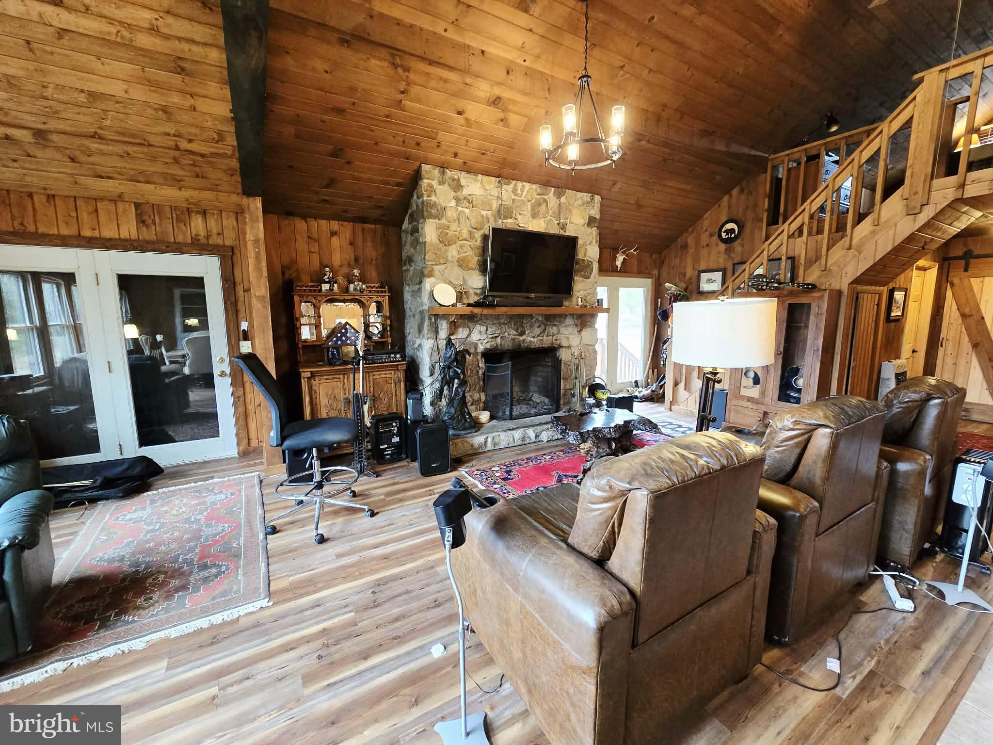 1120 Sandy Ridge Road Sugar Grove, WV 26815 - Photo 9 of 53 a living room with furniture flat screen tv and a fireplace