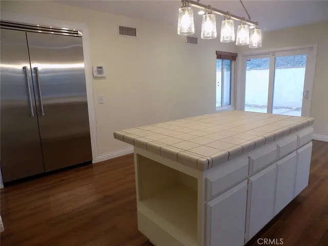 a kitchen with cabinets and wooden floor
