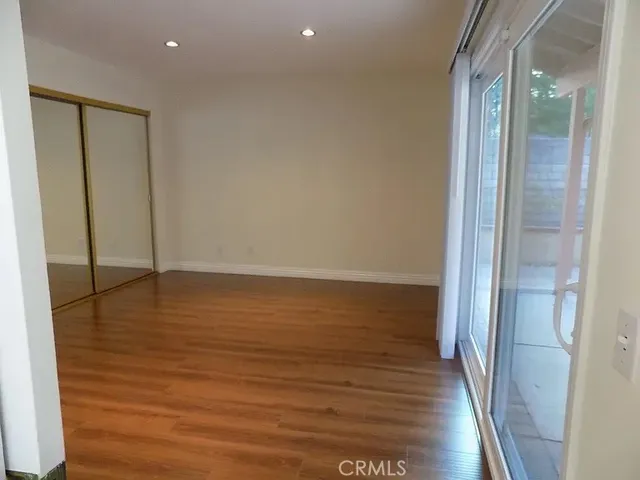 a view of a room with wooden floor and brick wall