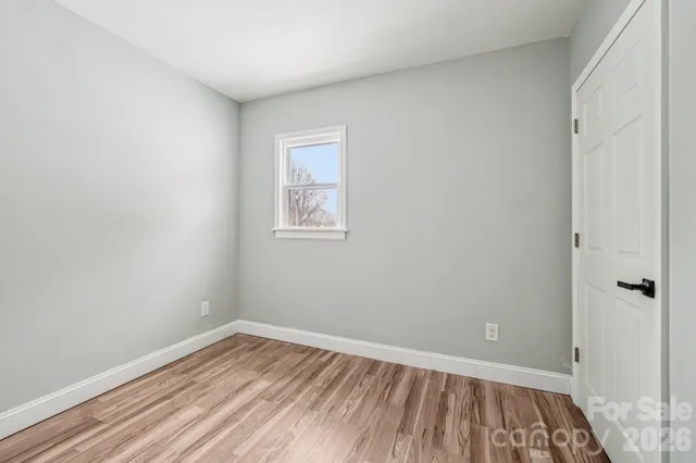 a view of a room with wooden floor and a window