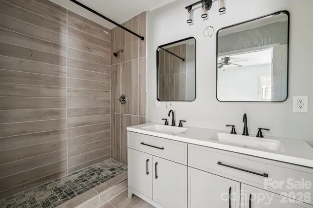 a bathroom with a double vanity sink mirror and