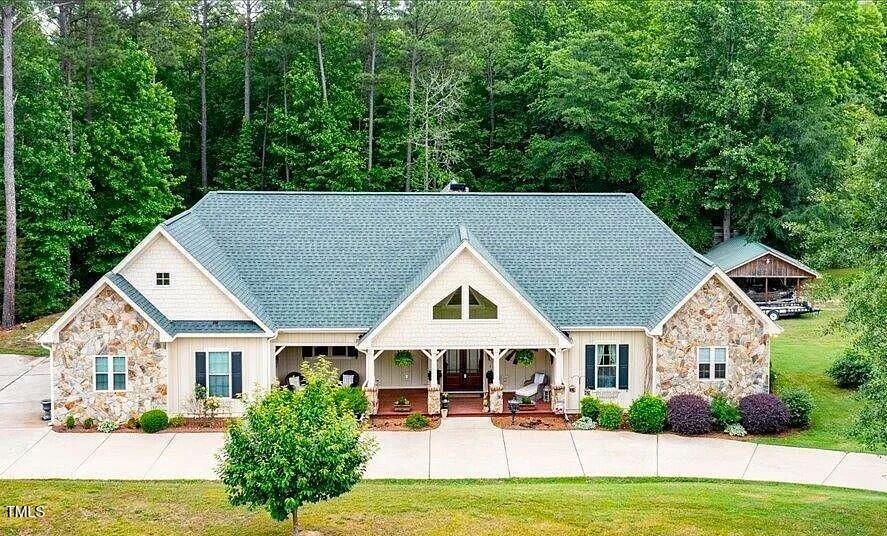 a view of house with yard and green space