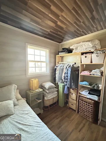 a bedroom with bed and a window