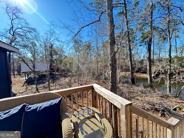 a view of a balcony with wooden fence and floor