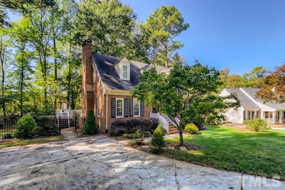 7301 Sandy Grove Court Raleigh, NC 27615 - Photo 1 of 28 a front view of a house with garden