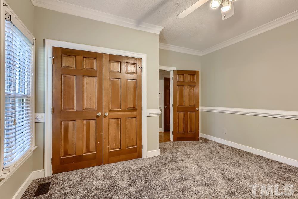 7301 Sandy Grove Court Raleigh, NC 27615 - Photo 14 of 28 a view of an empty room with wooden floor and a window