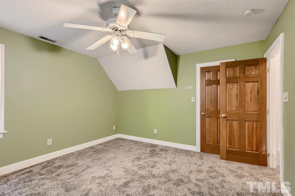 7301 Sandy Grove Court Raleigh, NC 27615 - Photo 20 of 28 an empty room with closet and a chandelier fan