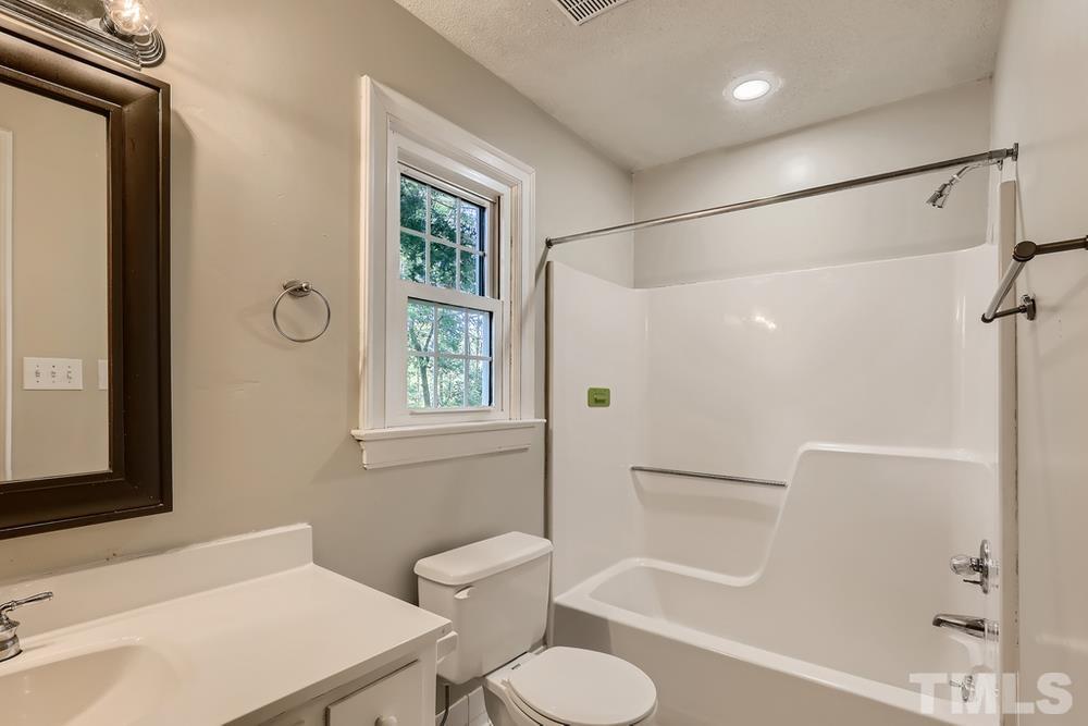 7301 Sandy Grove Court Raleigh, NC 27615 - Photo 21 of 28 a bathroom with a sink toilet and shower