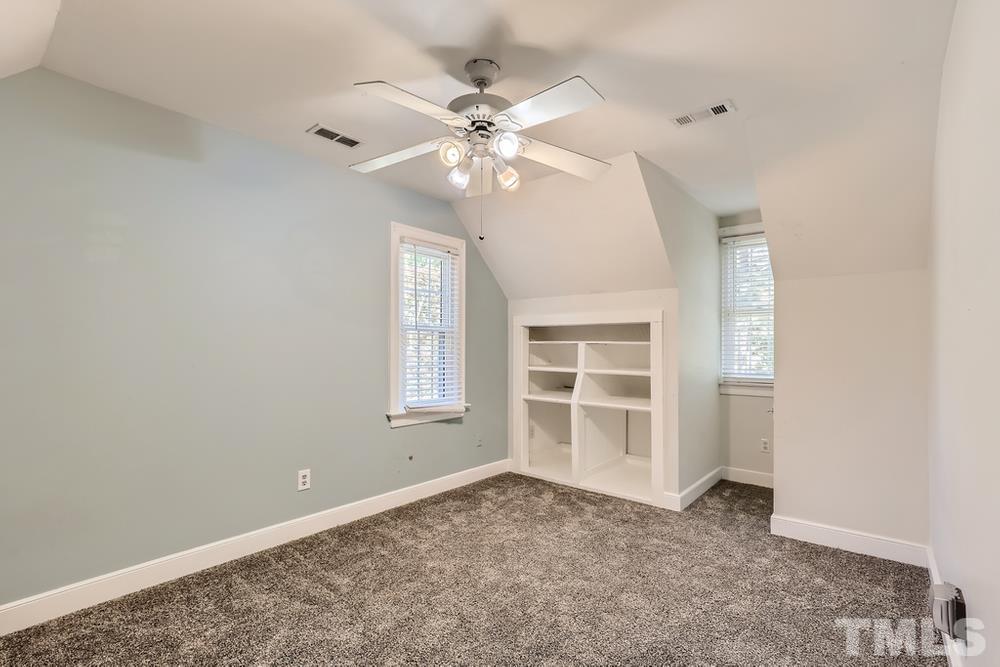 7301 Sandy Grove Court Raleigh, NC 27615 - Photo 22 of 28 an empty room with windows and ceiling fan