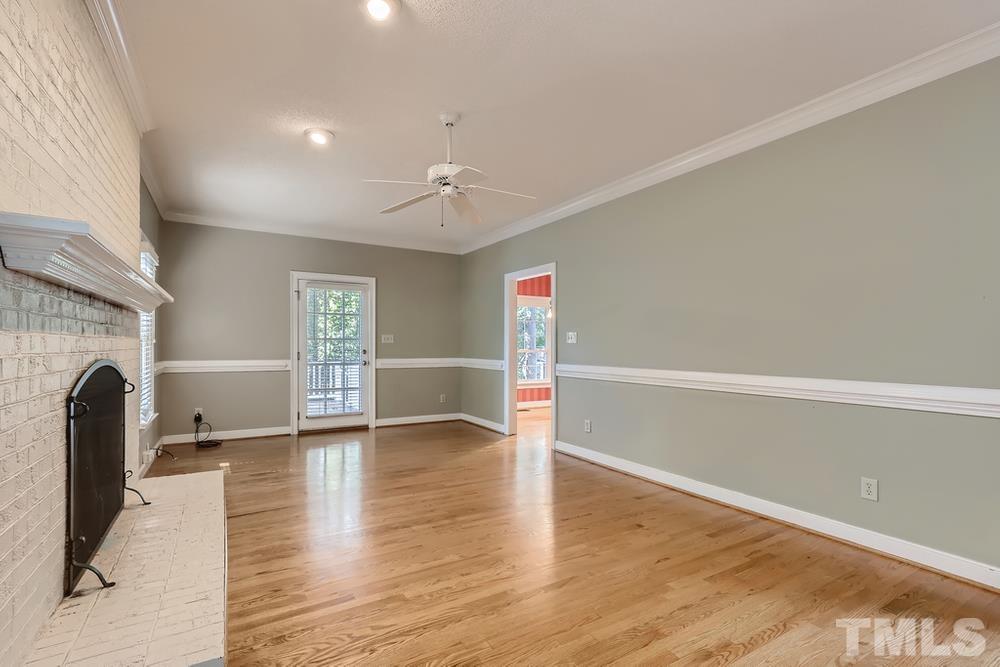 7301 Sandy Grove Court Raleigh, NC 27615 - Photo 5 of 28 a view of empty room with wooden floor and fan