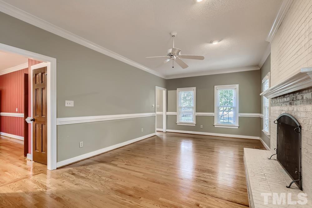 7301 Sandy Grove Court Raleigh, NC 27615 - Photo 6 of 28 a view of an empty room with window and wooden floor