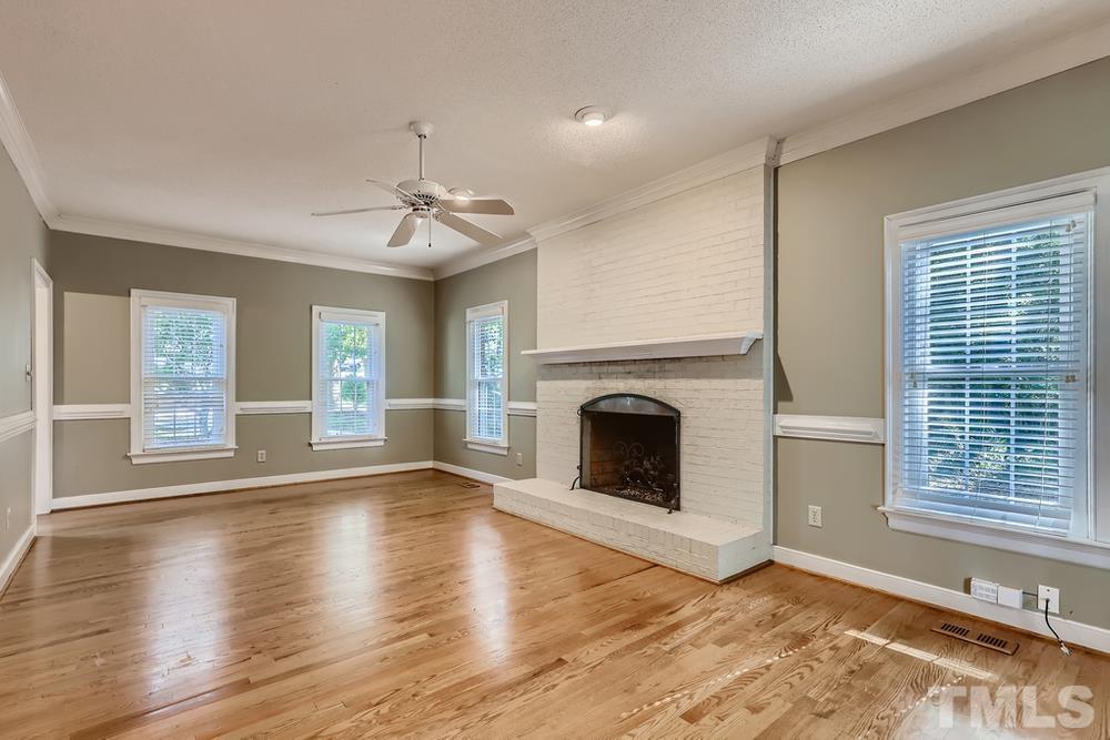 7301 Sandy Grove Court Raleigh, NC 27615 - Photo 7 of 28 a view of an empty room with wooden floor and a window