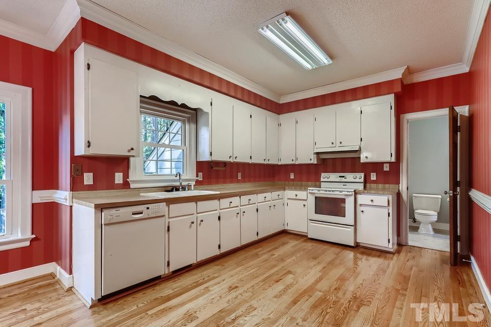 7301 Sandy Grove Court Raleigh, NC 27615 - Photo 8 of 28 a kitchen with a sink wooden floor and stainless steel appliances
